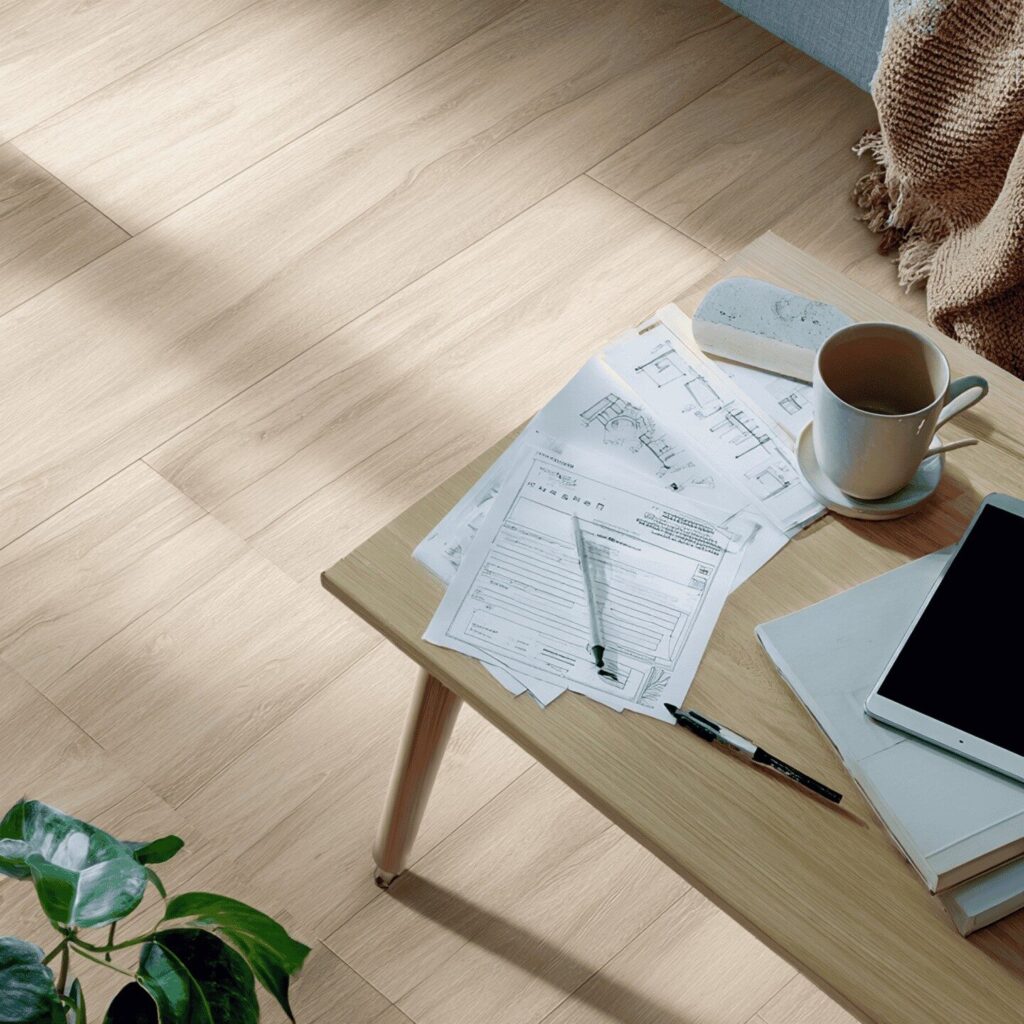 Coffee, design plans, ipad on a wooden table