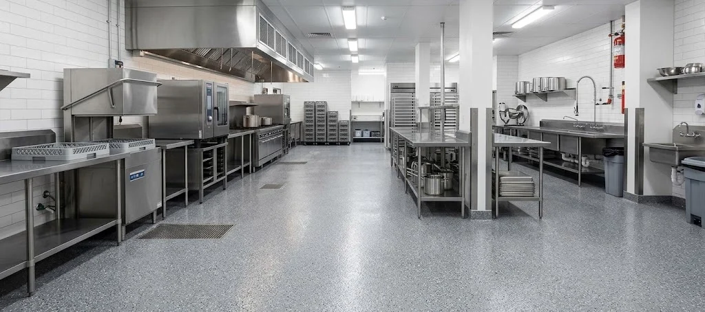 Seamless grey epoxy flooring in a commercial kitchen.
